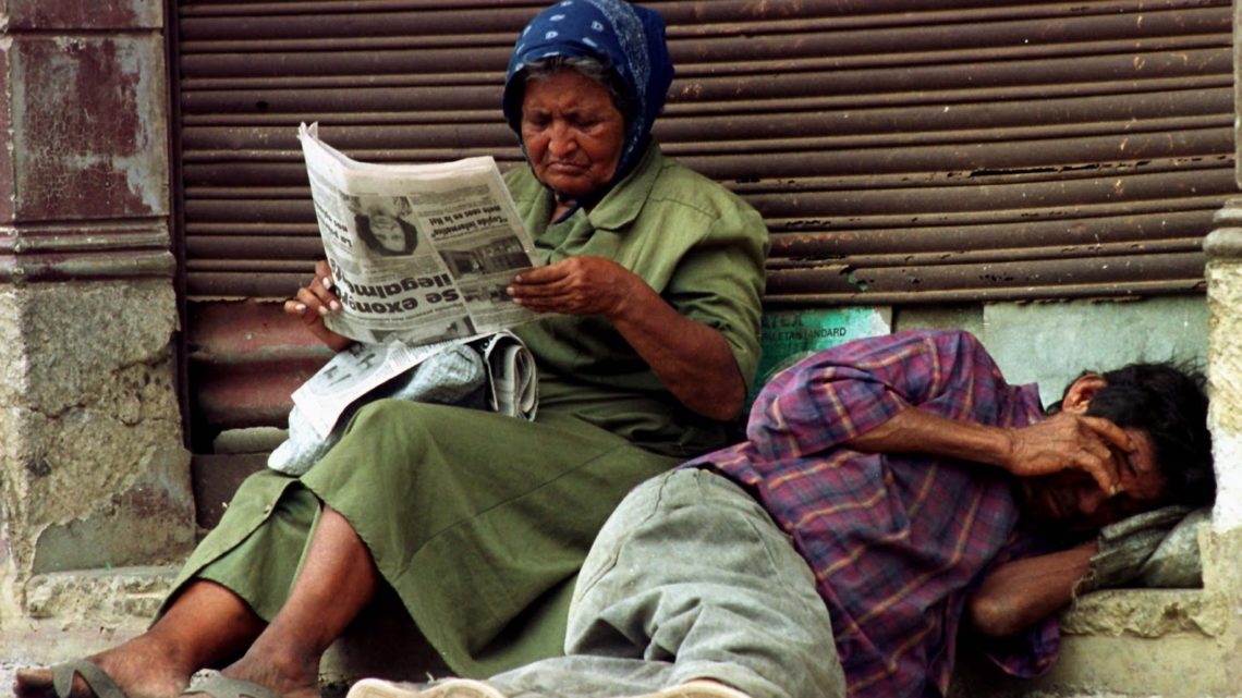 A woman reads a newpaper next to her sleeping husband on a street in old Managua. May 4. According to a report of the Program of the United Nations for Developmet (PNUD), Nicaragua is among the nations with the highest percentage of extreme poverty and general poverty in the world with 29% of extreme poverty and 50% of general poverty.

OR